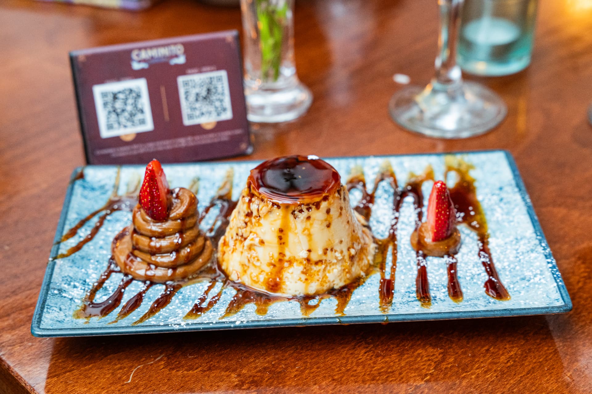 Homemade flan with dulce de leche and strawberries
